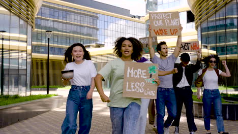 multicultural group protesting for saving the planet while walk towards the camera