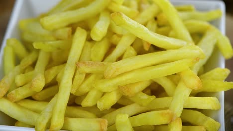 portion of fresh made french fries on a rotating plate (seamless loopable)