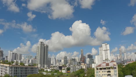 clouds over high-rise buildings in phrom phong neighborhood in bangkok, thailand. - timelapse shot