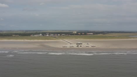 drone - aerial panorama circling shot of the sandy beach with tourists and people in st. peter ording at the north sea, schleswig holstein, germany, 25p