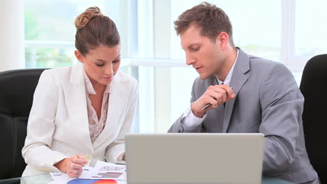 Colleagues-working-behind-a-laptop