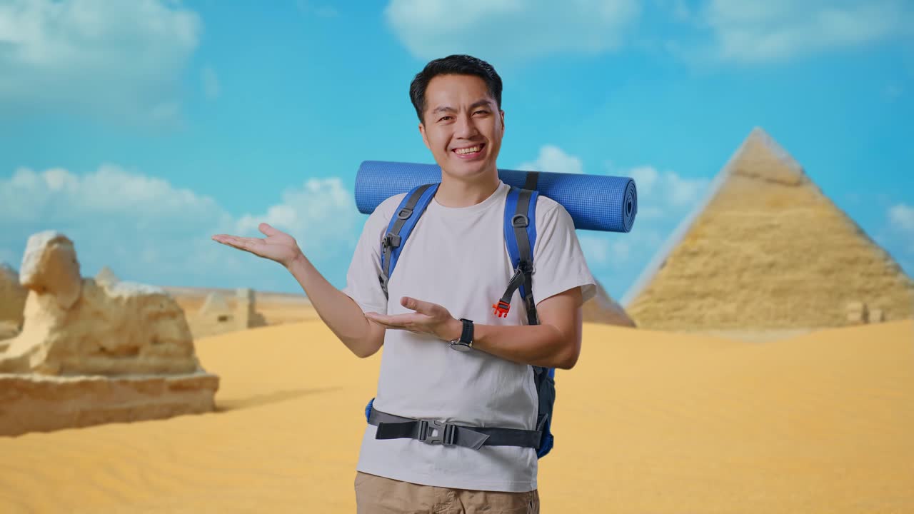 Asian Male Hiker With Mountaineering Backpack Smiling And Pointing To Side While Traveling In Pyramid Of Giza