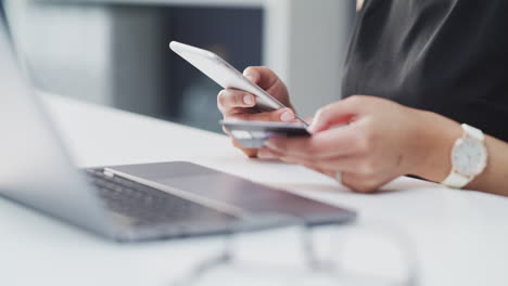 an-unrecognisable-businesswoman-using-a-cellphone