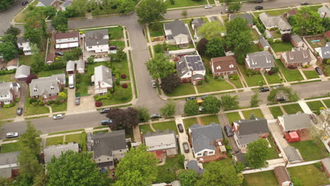 an aerial view over a suburban neighborhood on a cloudy day