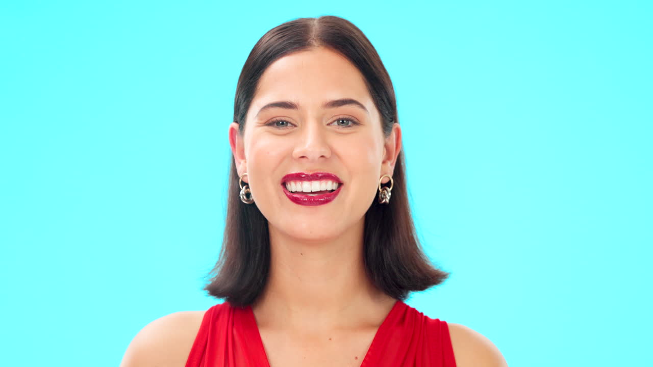 Happy, woman and winking face on blue background