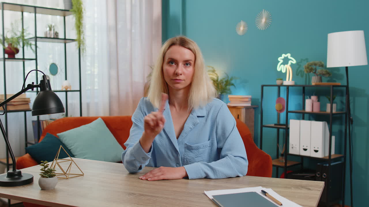 Business woman shakes finger saying no be careful avoid danger mistake disapproval sign at office