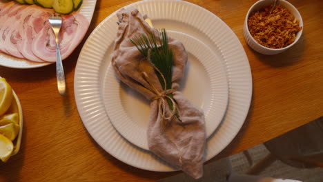 rustic linen napkin tied with twine on a ceramic plate