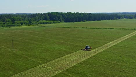 aerial of a tractor working on a green field