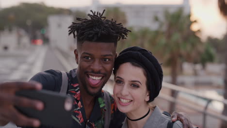 portrait happy multi ethnic couple using smartphone taking selfie photo making faces enjoying fun vacation together slow motion