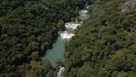 Spectacular-aerial-shot-of-waterfalls-in-the-middle-of-the-tropical-forest-between-mountains