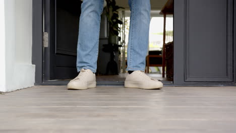 receiving package delivery, man picking up box at home entrance, copy space