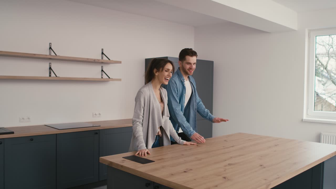 Caucasian couple very excited while watching their new house