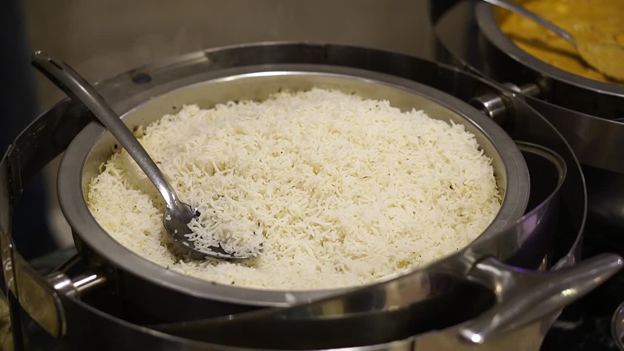 Bowl of white rice with steam coming off. Wedding catering view.