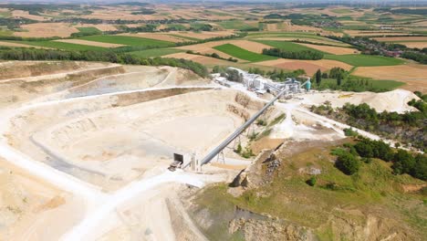 Aerial-View-Of-Limestone-Mine-Overlooking-The-Countryside-Fields-In-Daytime