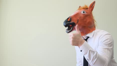 businessman with horse head on olive background shows thumb up businessman with horse head on olive background shows thumb up high quality video