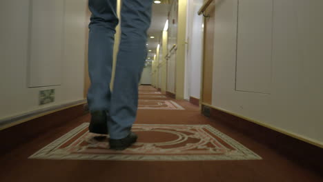 fast walking man along a corridor of ocean cruise liner