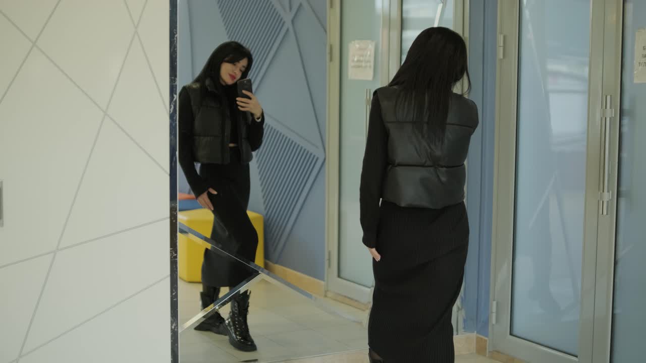 gerente femenina tomando una selfie en el espejo en la oficina