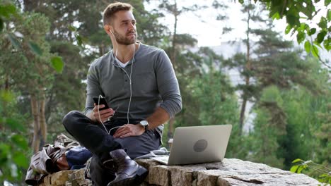 young man listening to music on smartphone