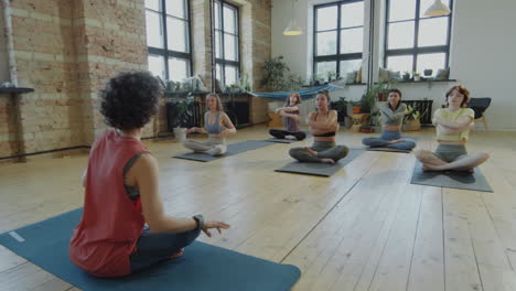 female instructor and women practicing yoga