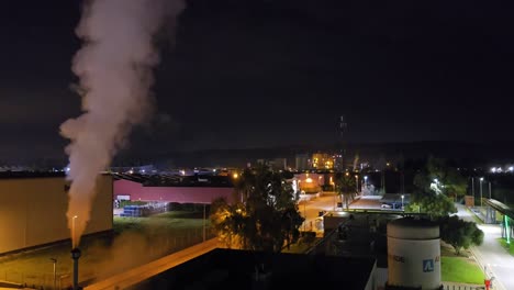 night view of an industrial factory with smoke stack