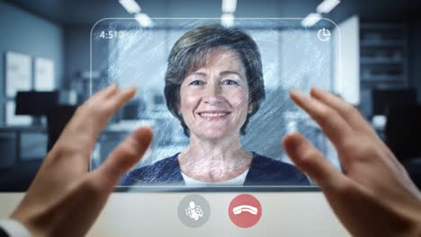 a professional woman appears on a digital display, engaging in a virtual meeting. the background features an office environment with a modern design. communication and collaboration are evident.