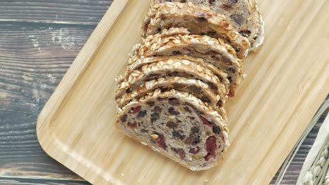 sliced fruit and nut multigrain bread on wooden tray