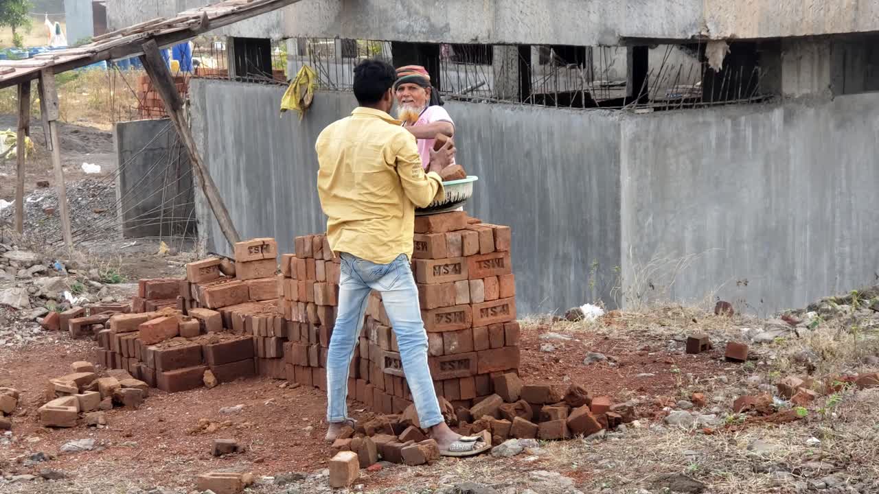 Construction Workers Laying Bricks at a Construction Site