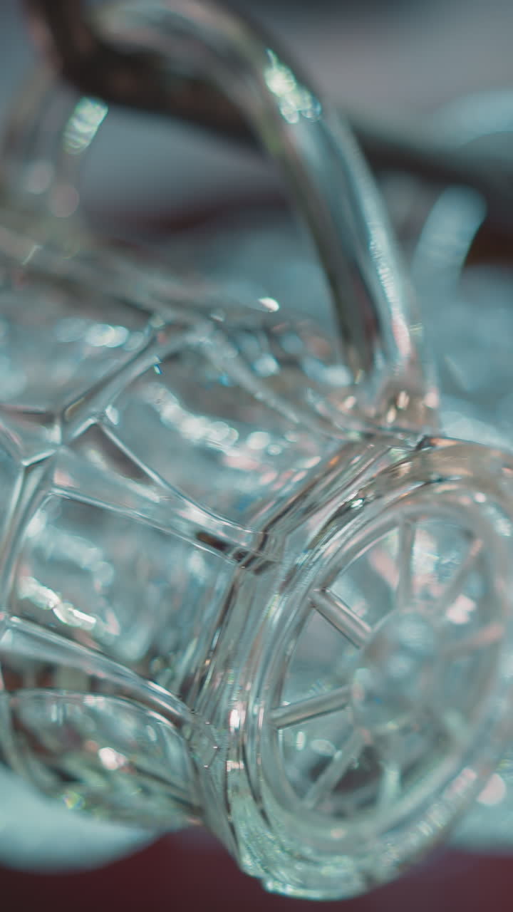 Textured glass mugs for beer drinks hang on rack in pub closeup. Glassware for ale and lager serving in bar. Public place with elegant glassware