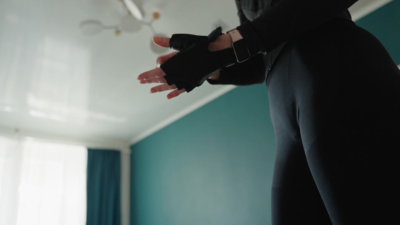 Woman begins workout. Confident woman starts exercise session. Selfassured female initiates fitness routine calmly. Woman at home prepares and advances to exercise area with confidence