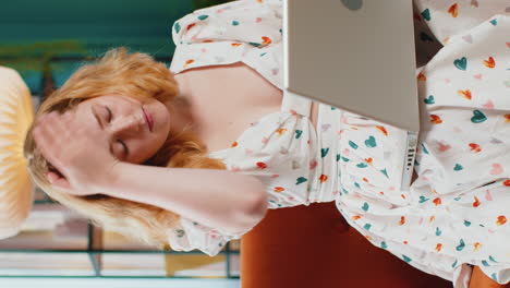 pretty redhead woman use laptop surprised by bad news fortune loss fail lottery results at home