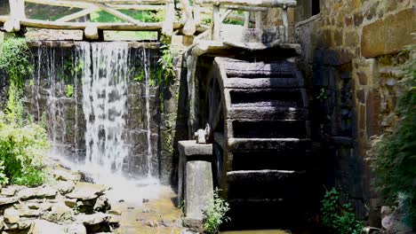 static video in the old mill in little rock, arkansas. water is flowing and a water wheel is slowly turning