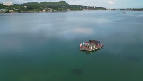 floating cottage resort in clear turquoise water near coastline, philippines