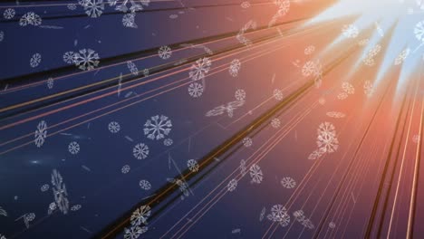 animation of snow falling over glowing orange rays on grey background