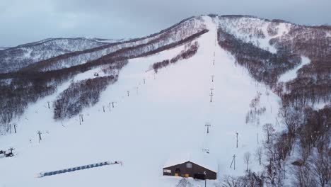 panning perspective shot of a rural backcountry ski slope in hokkaido, japan.