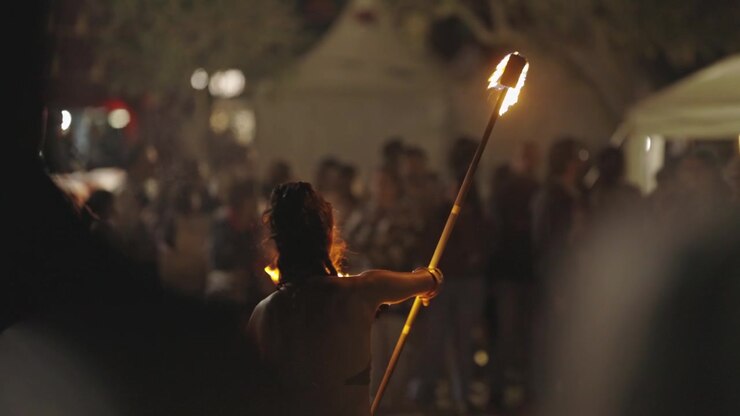 A woman performing a fire show outdoors