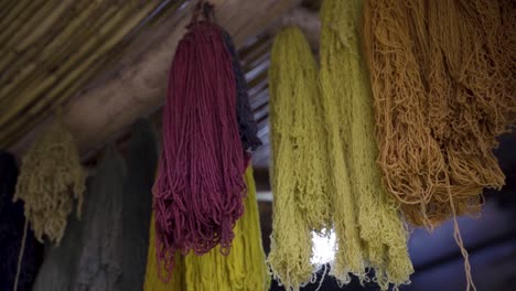 hand dyed wool by artisans hanged from ceiling in chinchero, cusco, peru