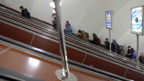 people moving on escalator in the st. petersburg metro in russia