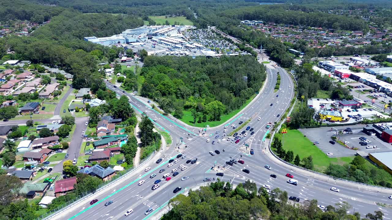 Drone aerial landscape car vehicles traffic transport at streetlights intersection with shopping centre Tuggerah Central Coast suburbs neighbourhood travel tourism urban