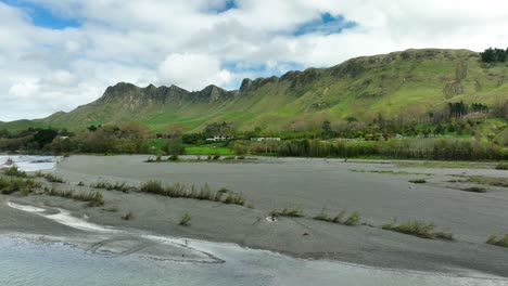 flying above tukituki riverbed showing rural landscape with farms in nz