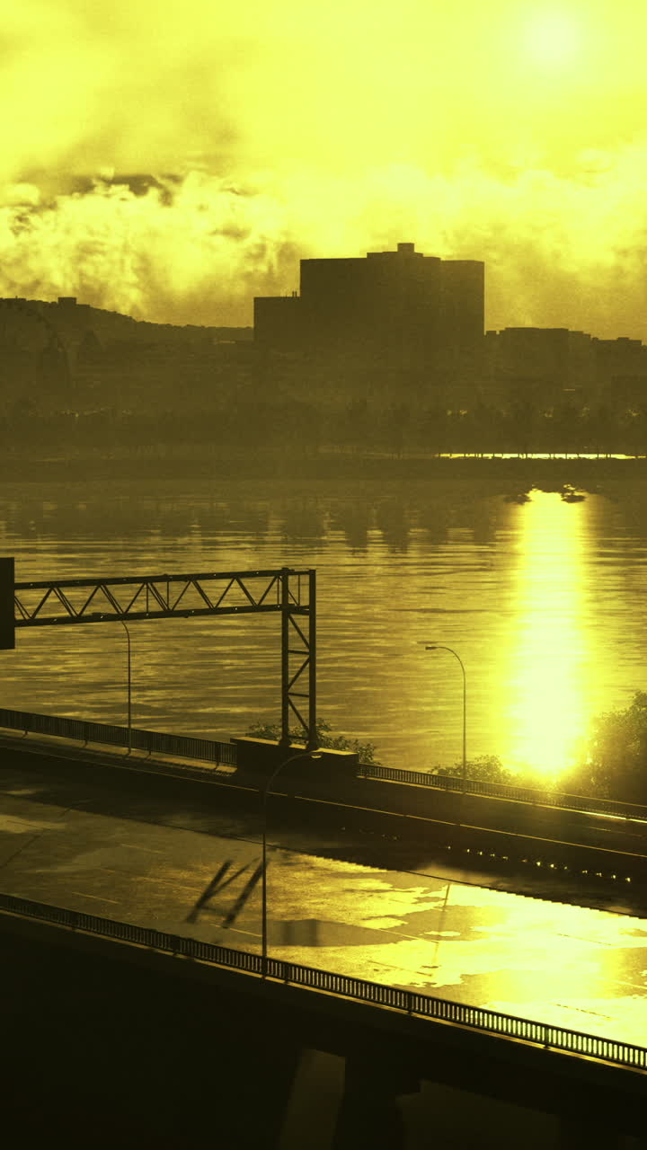 Golden sunrise over city skyline and river with highway in foreground