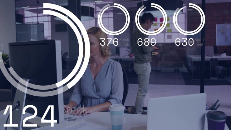 Woman typing in business while circular gauges peaking falling as peer placing notes tracking KPIs