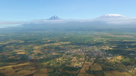 aerial view high above rural kenya, kilimanjaro background - pull back, drone shot