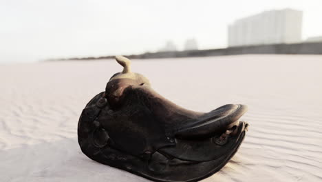 old horse saddle on the beach