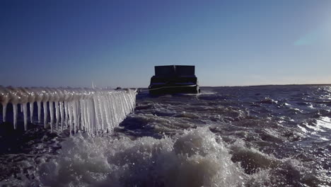 ice-covered rope and boat on a frozen river