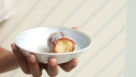 a bite of delicious indian dessert - gulab jamun