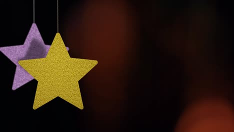 los adornos de las estrellas de navidad se mueven en el fondo de bokeh.