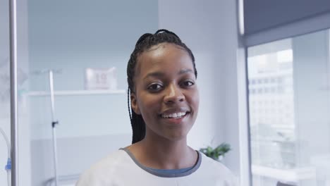 Portrait-of-happy-african-american-female-patient-in-hospital-room,-slow-motion