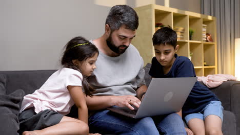 father, daughter and son in the living room at home