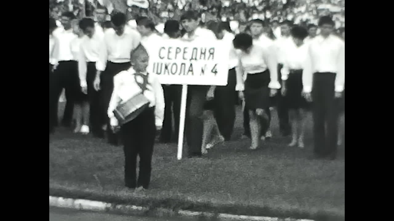 People Marching Down a Field. CIRCA USSR 1970: People Marching Down a Field