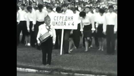 people marching down a field. circa ussr 1970: people marching down a field
